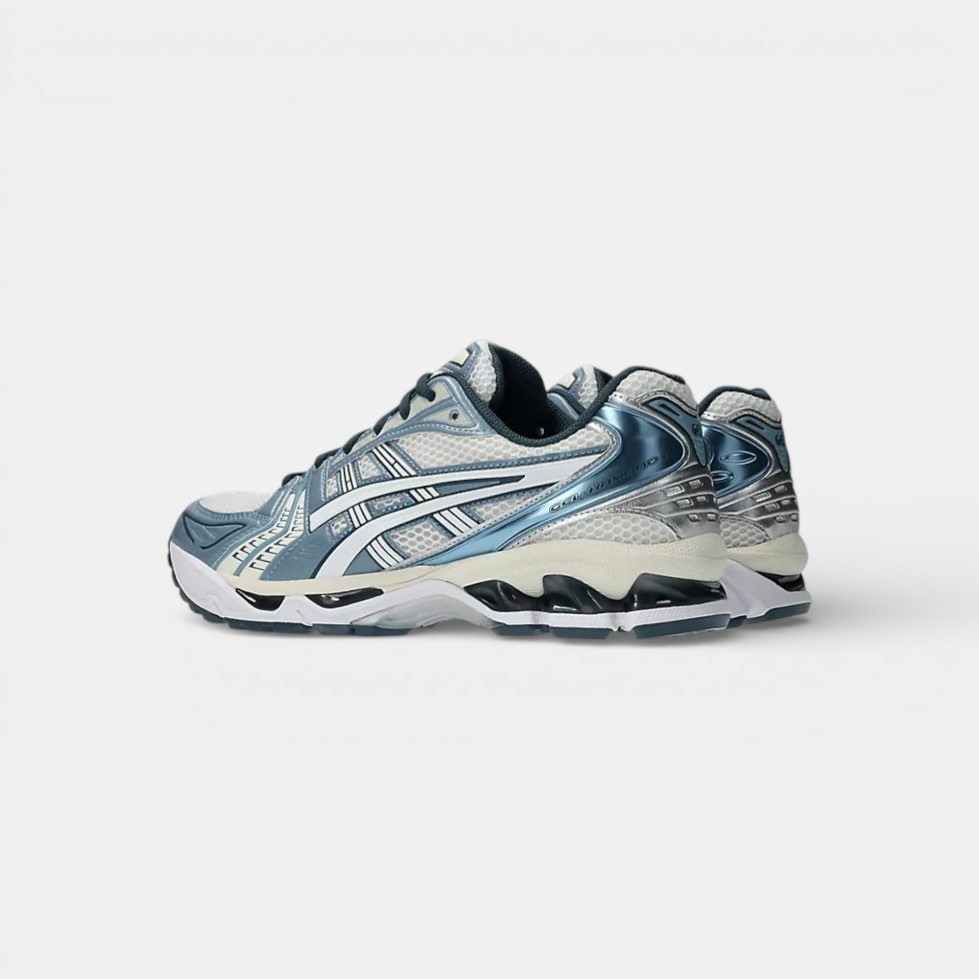 ASICS Gel-Kayano 14 running shoes in cream, raw indigo, and silver. Mesh upper with synthetic overlays and GEL cushioning.